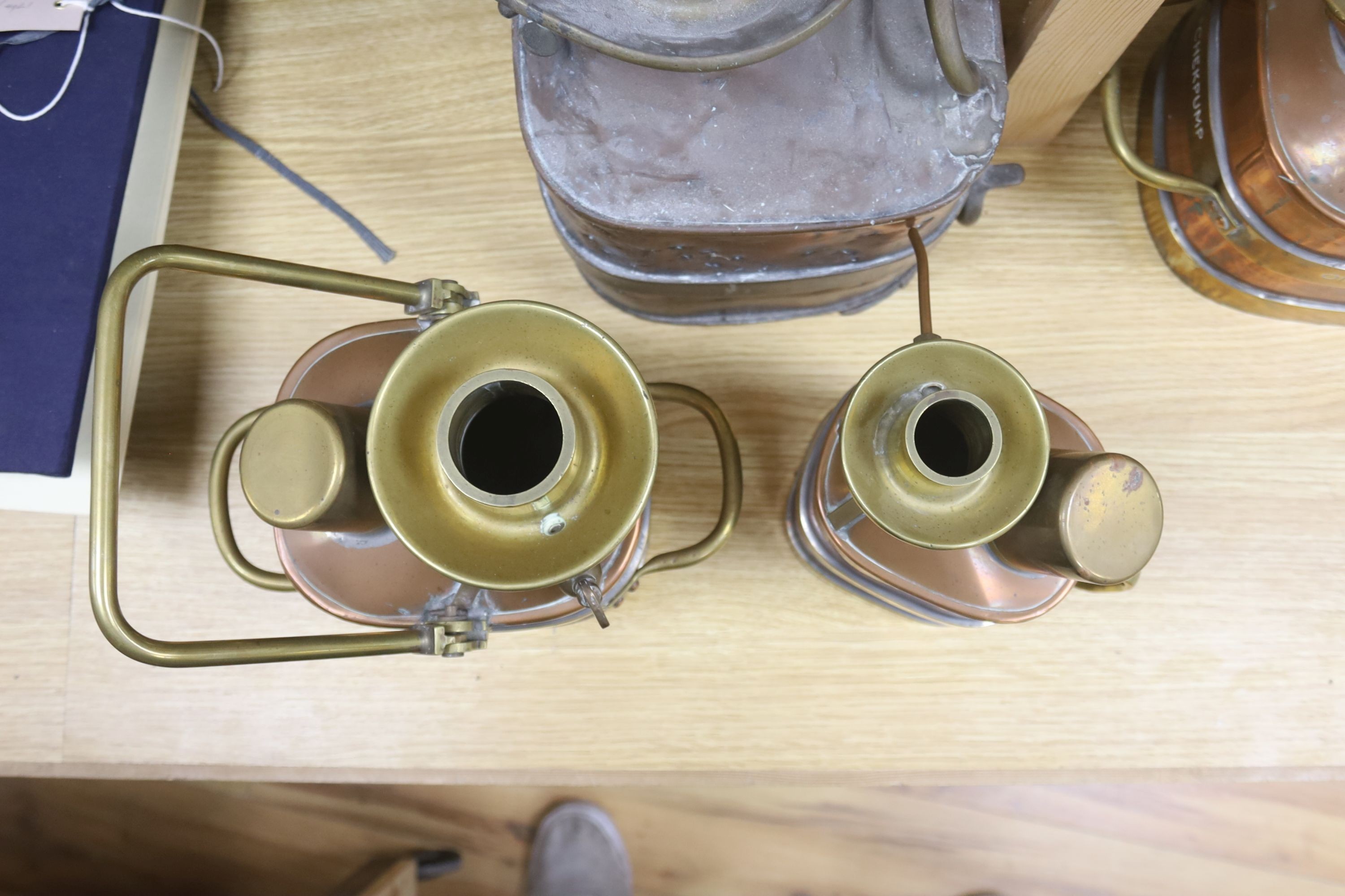 A group of four copper and brass mounted checkpumps, from quart size to one gallon, largest 28cm